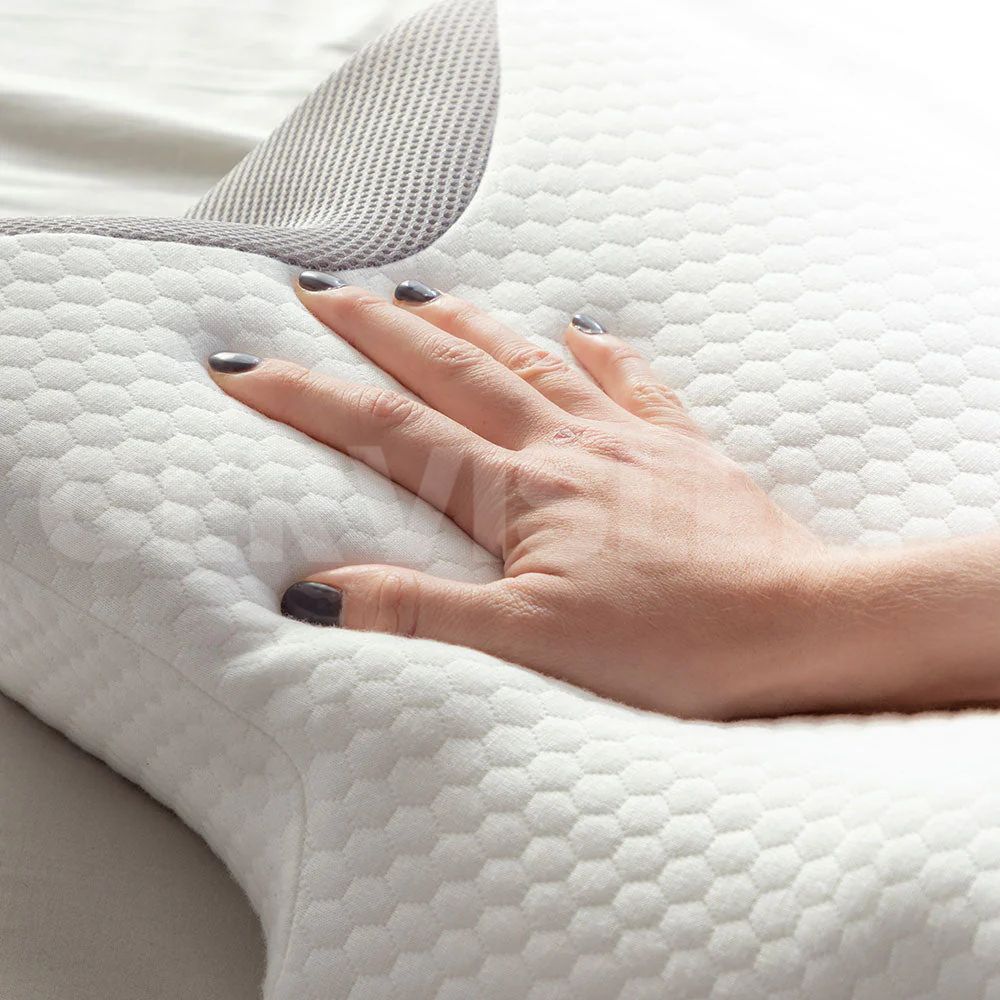 Hand pressing into CerviSleep™ memory foam pillow, demonstrating soft and adaptive comfort